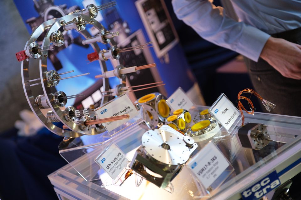 Detail einer Vakuum-Messapparatur mit Spulen und Halterungen auf einem Ausstellerstand