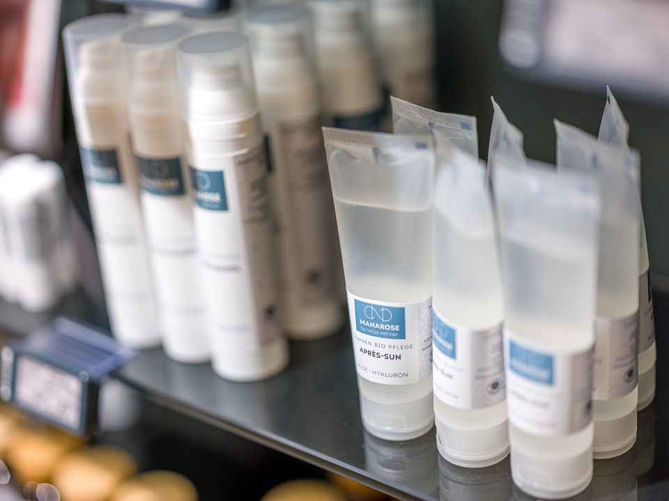 Nahaufnahme von Pflegeprodukten der Eigenmarke Manarose auf dem Regalboden